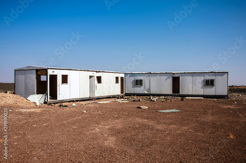Abandoned construction trailers in the desert, Harrat Kishb, Saudi Arabia photo