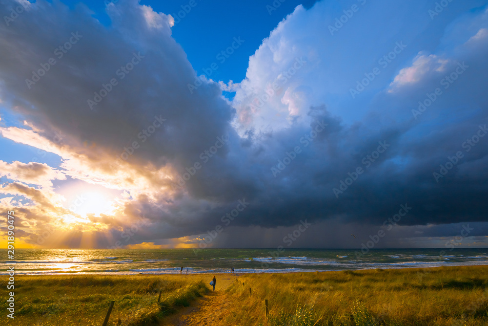 Fototapeta premium Fast weather change after days rather boring weather. Welcomed by the people. Baltic Sea in summer. People did not even shy away from approaching lightning and thunder. (The photographer fled...)