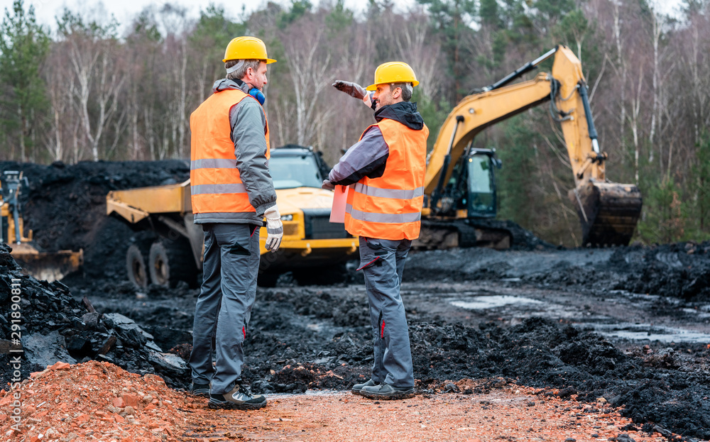 Two quarry workers discussing what to do next Two quarry workers discussing what to do next