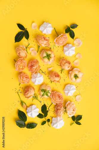 Floral pattern with pink roses and merengues on yellow background