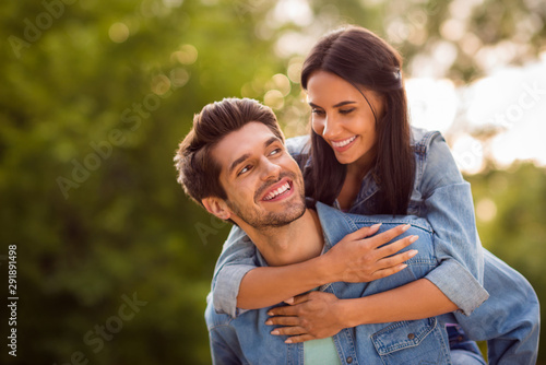 Close up photo of lovely sweethearts looking piggyback wearing denim jeans jackets outdoors