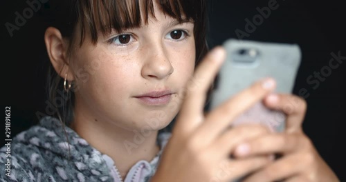 Teenager girl is using smartphone for browsing social network for chatting