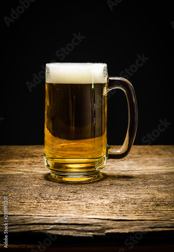 glass of beer on wooden background