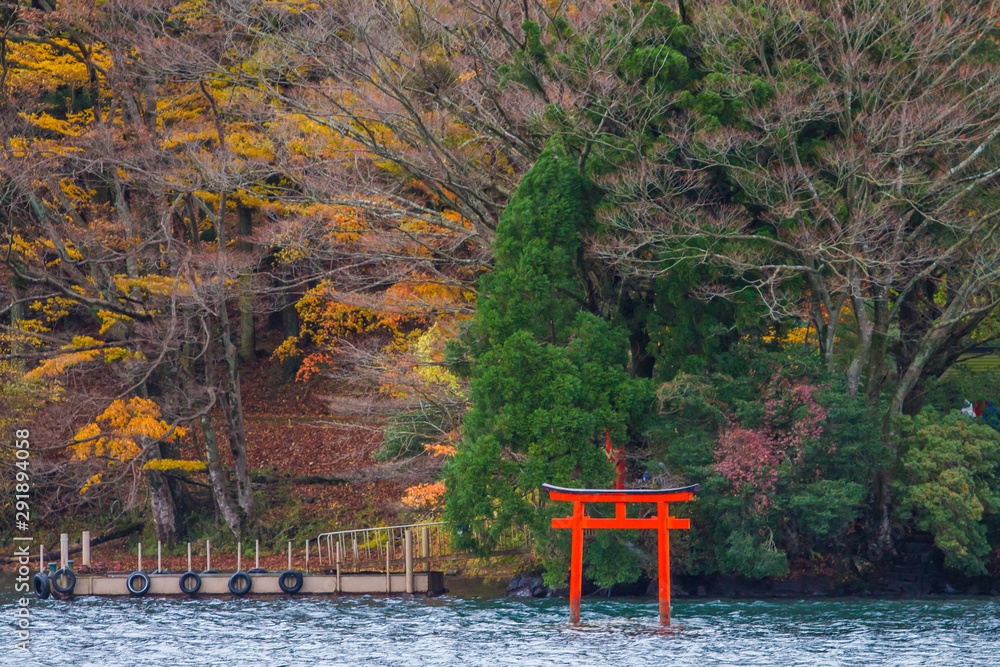 Red torii gate at Lake Ashi of Hakone shrine with twilight sky before ...