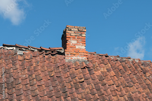 Old clay tile roof and sky. © Janis Smits
