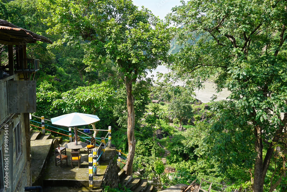 Rustic Outdoor cafe over looking jungle river 