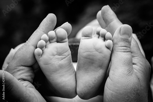 Baby feet in mothers hands.