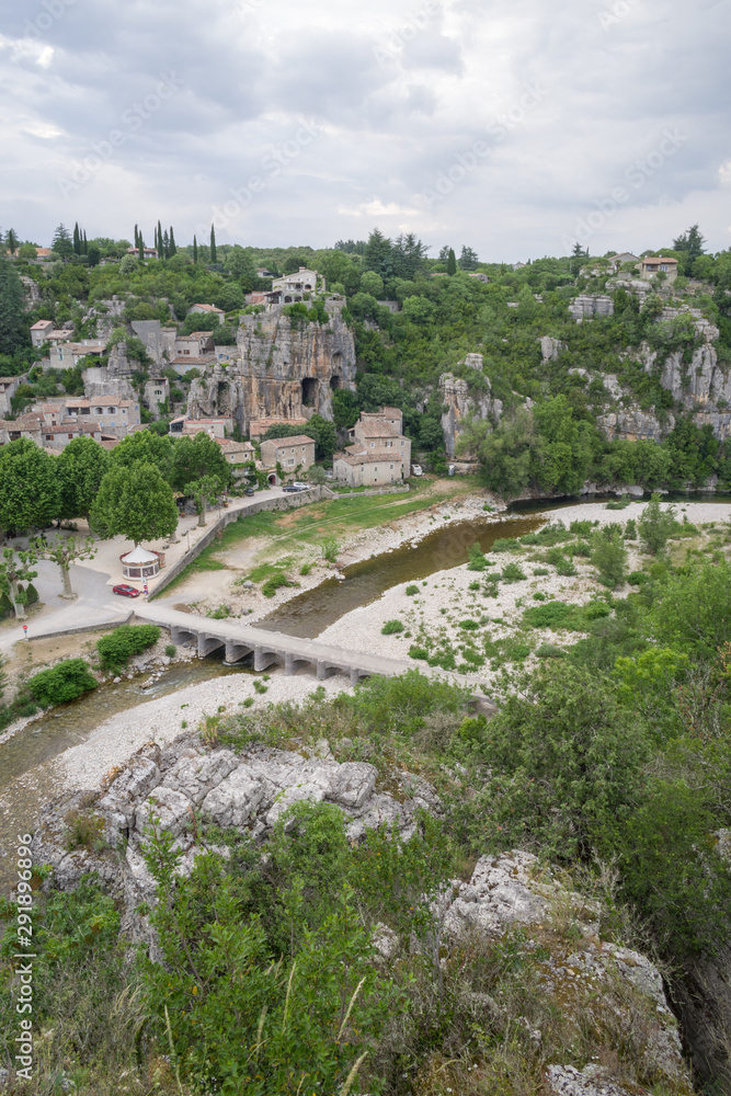 Remote view of the small village of Labeaume in Ardèche during a cloudy summer day, France.