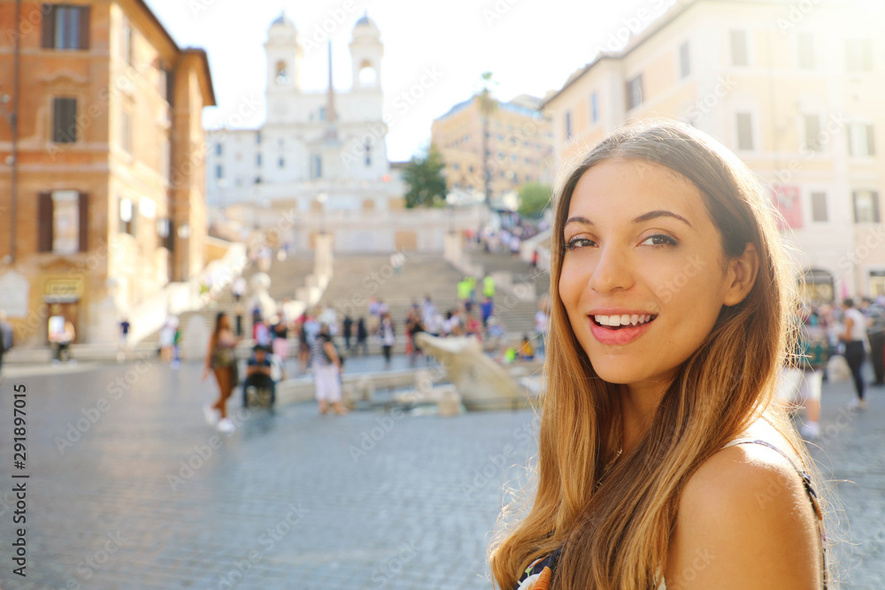 Close up of beautiful fashion woman in Piazza di Spagna square in Rome with Spanish Steps and Barcaccia fountain on the background.