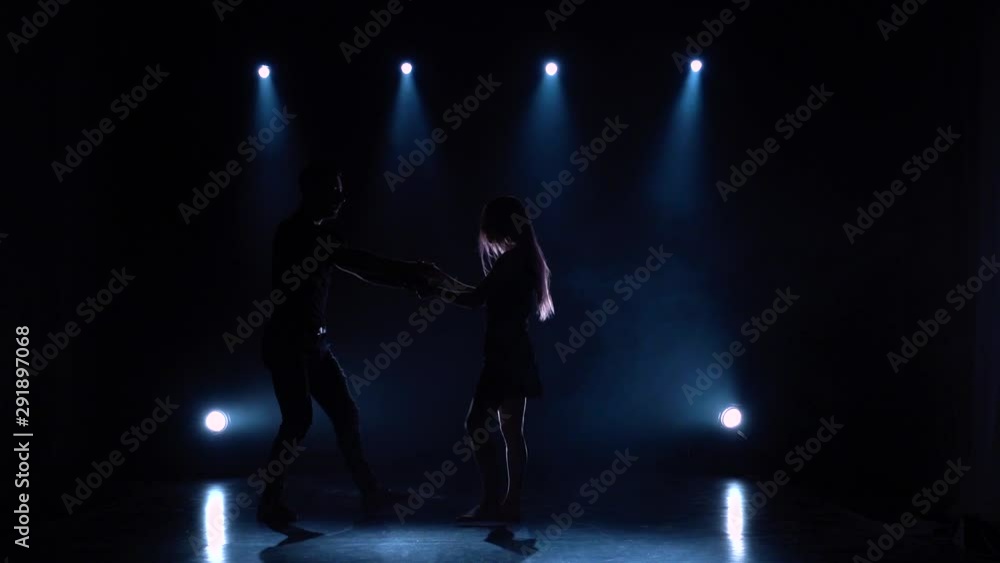 Dances contemp performed by two ballroom dancers, slow motion. Silhouette Dances contemp performed by two ballroom dancers, slow motion. Silhouette