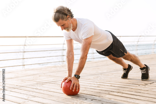 Image of sporty old man doing exercise with medicine ball © Drobot Dean