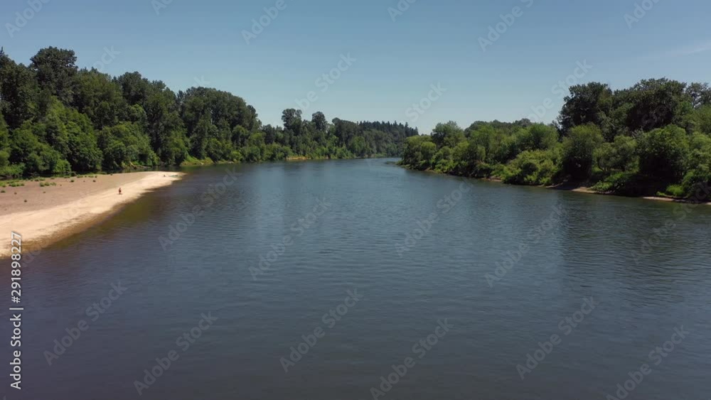 river low aerial dolly over water with trees and beaches and blue sky river low aerial dolly over water with trees and beaches and blue sky