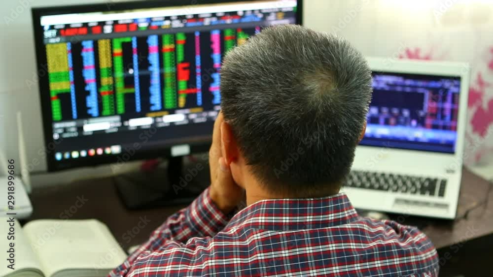 Trader or broker monitoring stock exchange from monitor , Chiangmai Thailand Trader or broker monitoring stock exchange from monitor , Chiangmai Thailand