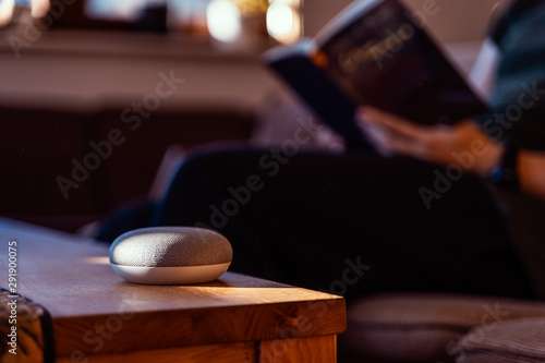 Smart ai speaker. Smart home concept with man reading in the background