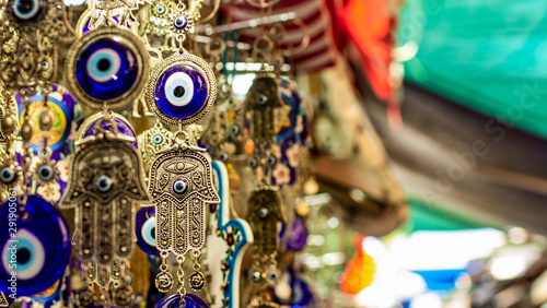 Israeli Eastern market with Jewish religion jewelry foreground and colorful blurred background 