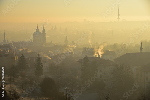 Winter morning in the Mala Strana (Czech: Malá Strana) district. View from the Strahov Monastery (Czech: Strahovský klášter). Sunrise. Fog. Prague, Czech Republic.
