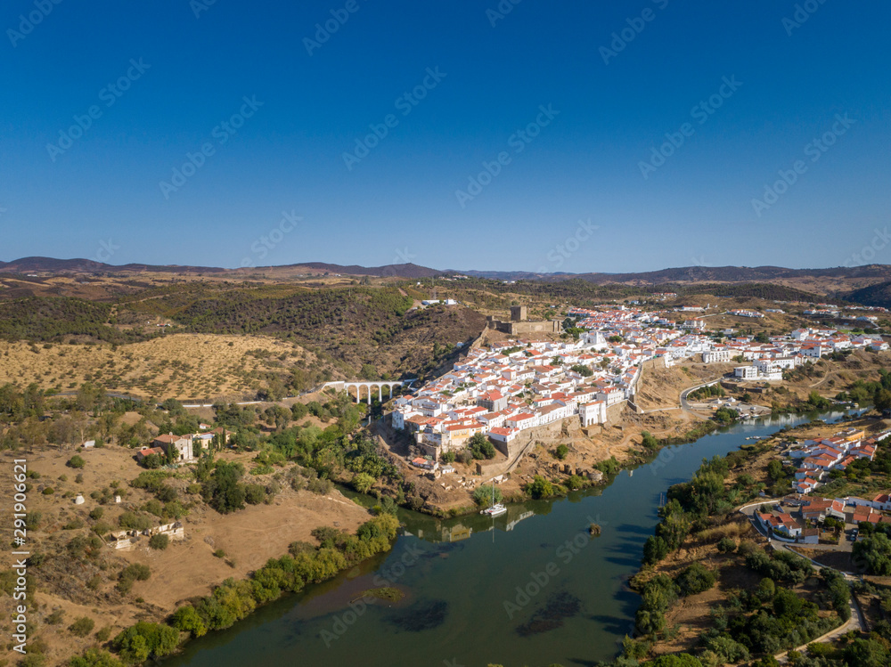 Aerial view of the town of Mértola in southeastern Portuguese Alentejo destination region, located in the margin of Guadiana River, whit its medieval castle, located on the highest point. Portugal.