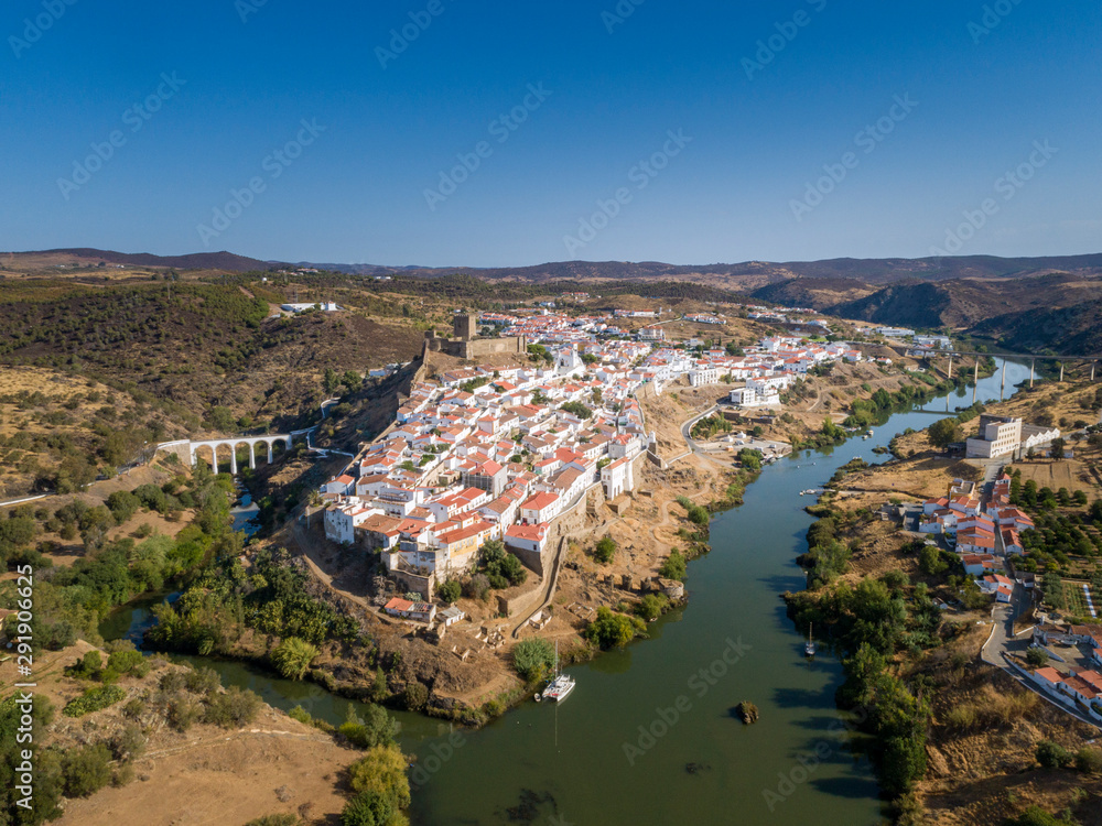 Aerial view of the town of Mértola in southeastern Portuguese Alentejo destination region, located in the margin of Guadiana River, whit its medieval castle, located on the highest point. Portugal.