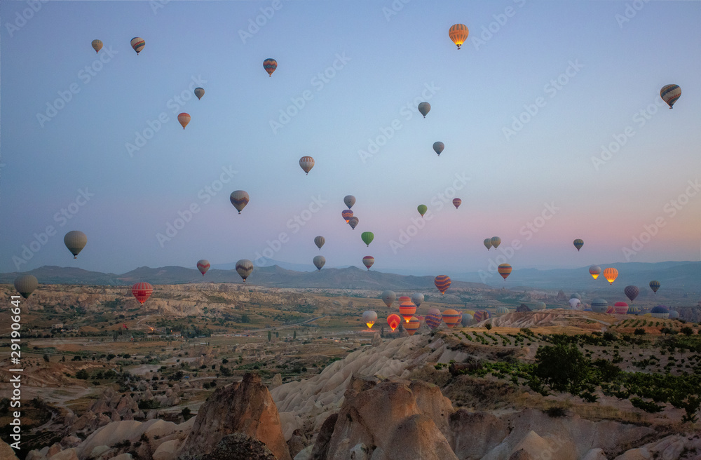 Interesting rocky terrain and a lot of airy multicolored balls in the air. Turkey. Cappadocia.