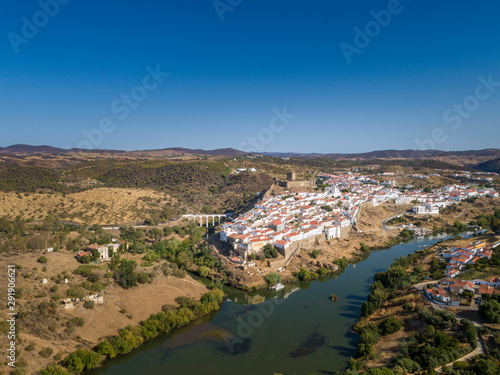 Aerial view of the town of Mértola in southeastern Portuguese Alentejo destination region, located in the margin of Guadiana River, whit its medieval castle, located on the highest point. Portugal. © Carlos Neto