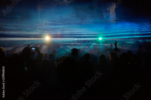 Crowd of people under holographic light