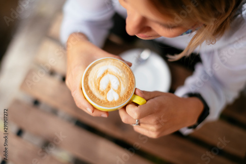 Top view of woman drinking coffee