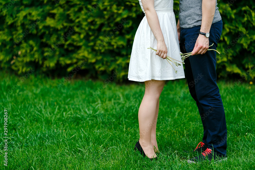 Feet of young couple on the green grass. Feet of young couple on the green grass.