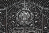 Vintage wrought iron gate with a female face