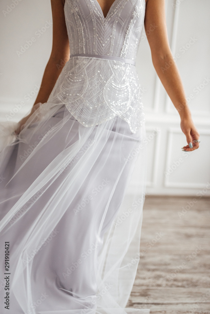 the bride in a beautiful dress is spinning in a white Studio
