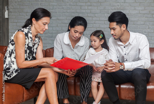 Asian Parent talking with teacher about Plan education for children. Young family and children discuss or advice with professional family psychologist in office