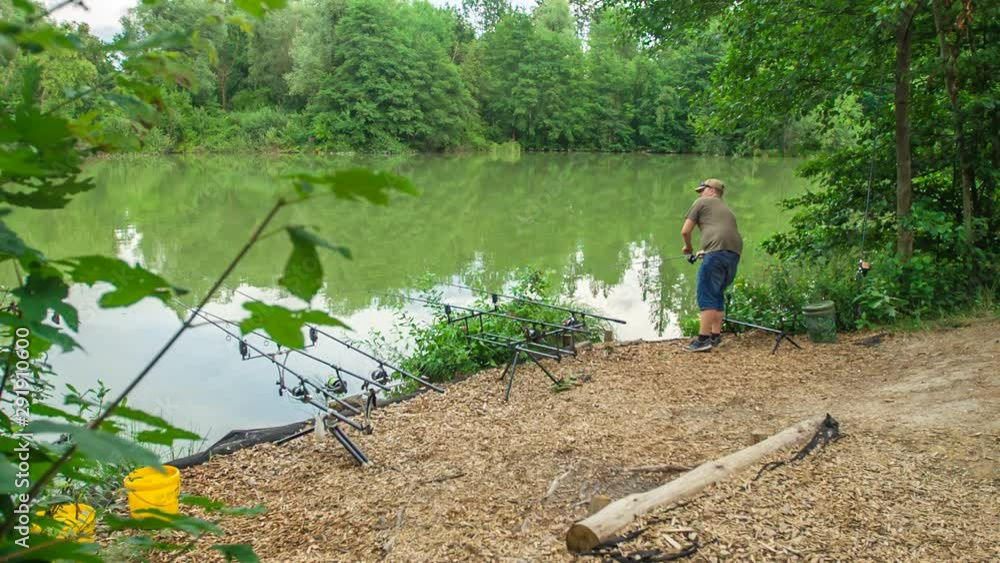 Beautiful green lake and nature. A fisherman is fishing. Beautiful green lake and nature. A fisherman is fishing.