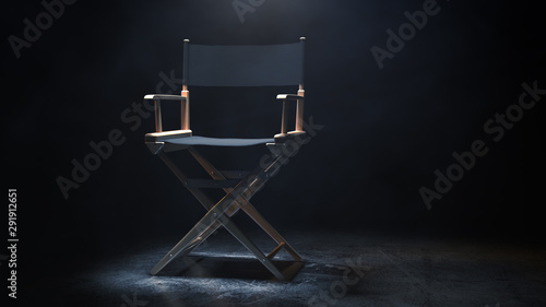 Bild auf Leinwand Director Chair, Movie Clapper and Megaphone in the volumetric light on a black background