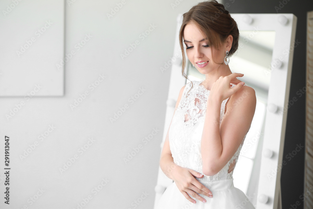 Beautiful young bride before wedding ceremony at home
