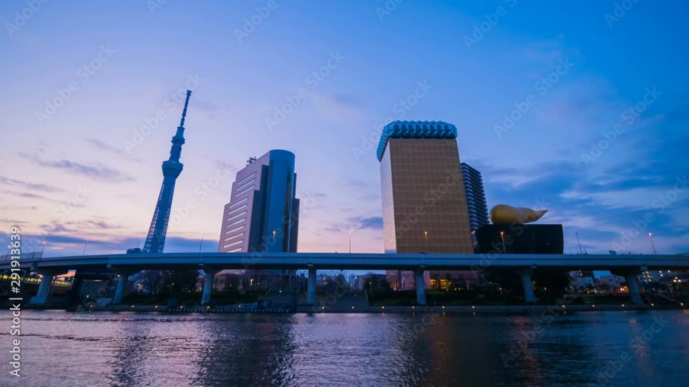 Day to night time lapse of Tokyo skyline on the Sumida River with sunrise, Japan