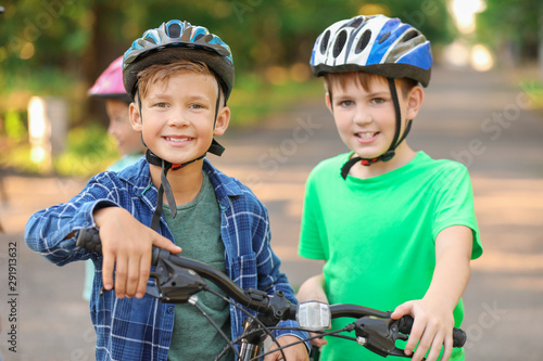 Cute children riding bicycles outdoors