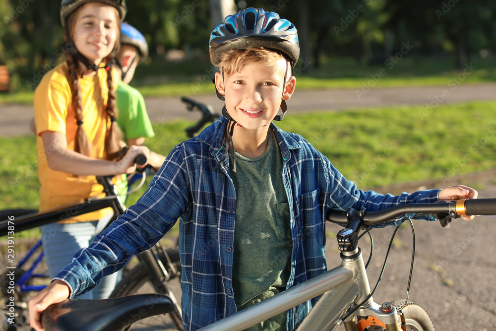 Cute children riding bicycles outdoors