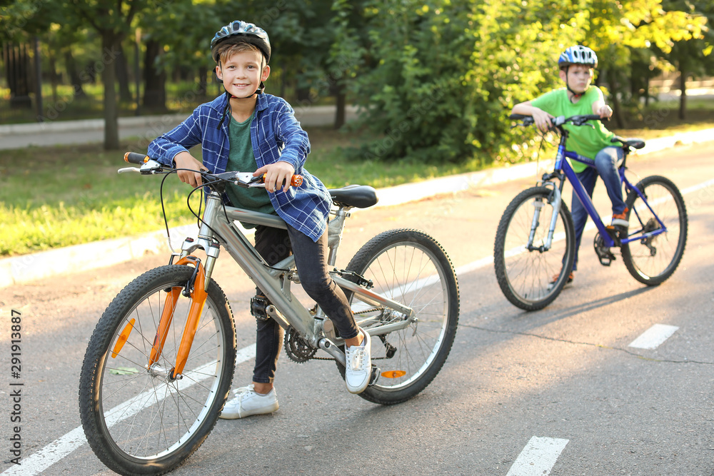 Cute children riding bicycles outdoors Cute children riding bicycles outdoors