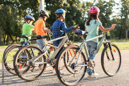Cute children riding bicycl...