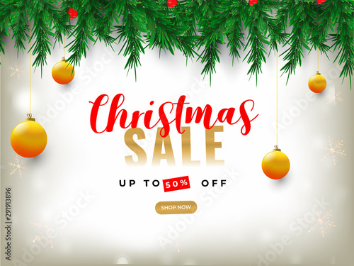 Advertising banner or poster design decorated with pine leaves, baubles hang and 50% discount offer for Christmas Sale.