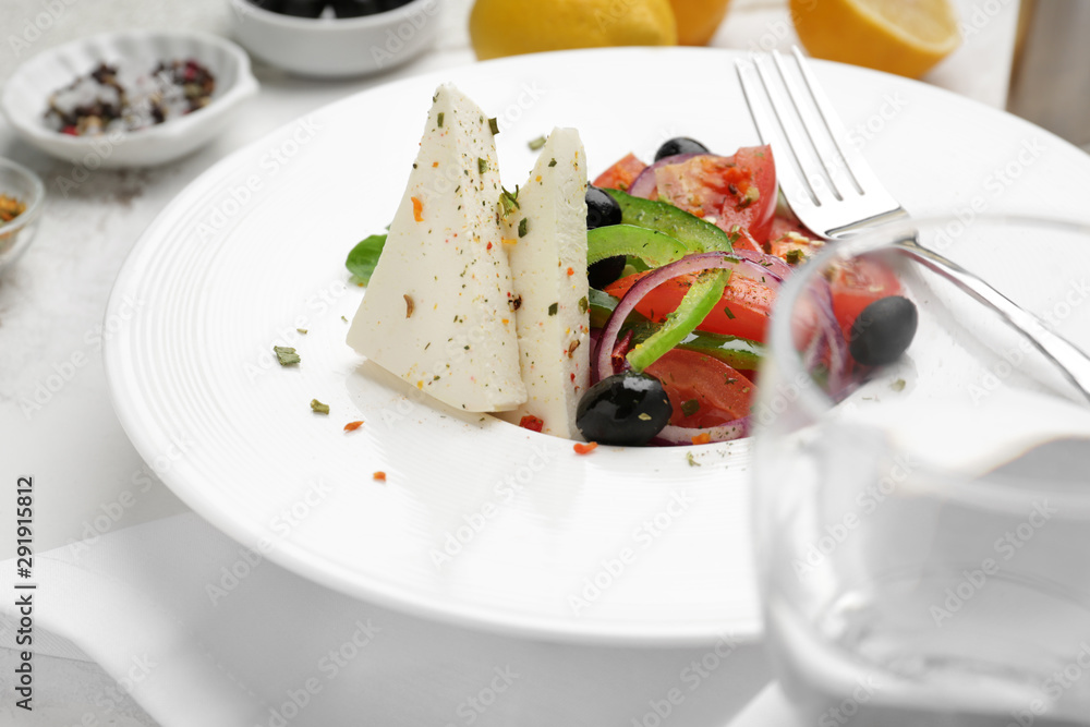 Plate with tasty Greek salad on table Plate with tasty Greek salad on table