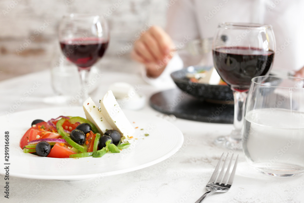 Plate with tasty Greek salad on table Plate with tasty Greek salad on table