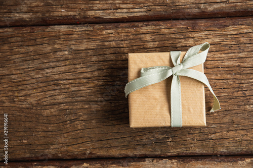 Simple wrapped gift on wooden table