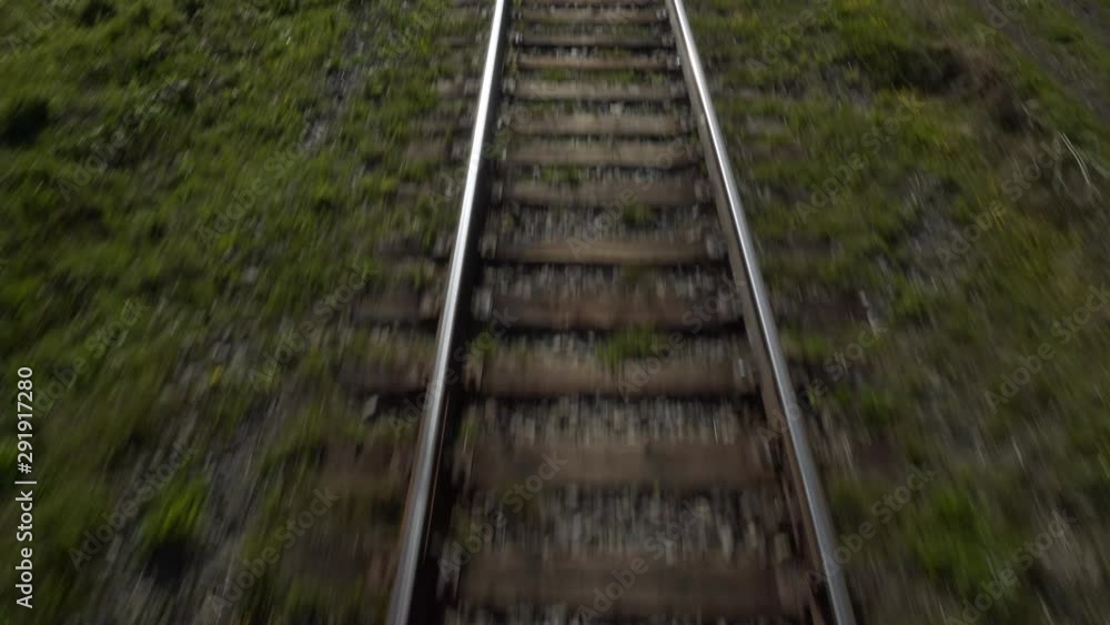 Close-Up: Railroad Tracks Next to Lush Green Mountain and Lake - Irkutsk, Russia Close-Up: Railroad Tracks Next to Lush Green Mountain and Lake - Irkutsk, Russia