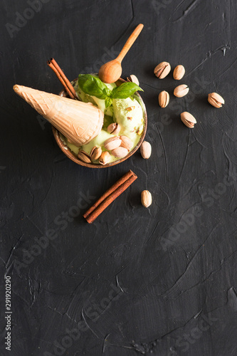  ice cream with pistachios and cinnamon on a dark background