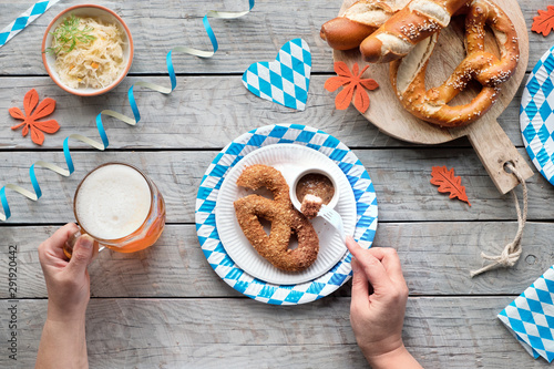 Oktoberfest traditional food and beer, flat lay on wooden table photo