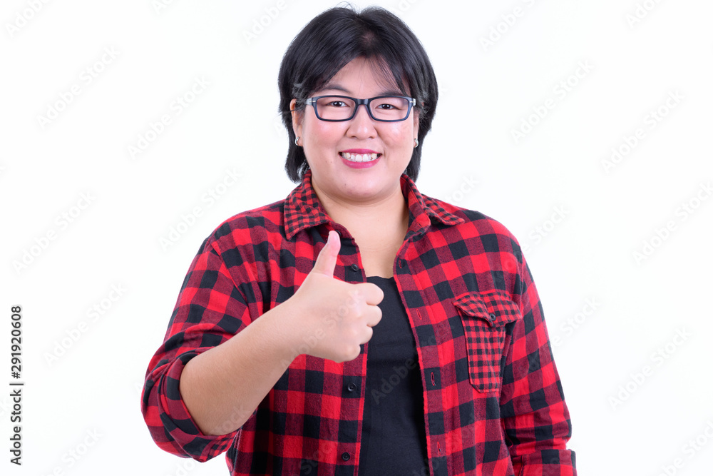 Happy overweight Asian hipster woman giving thumbs up Happy overweight Asian hipster woman giving thumbs up