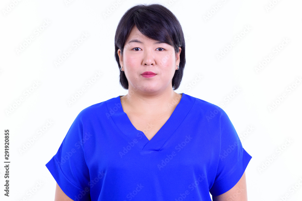 Face of beautiful overweight Asian businesswoman looking at camera Face of beautiful overweight Asian businesswoman looking at camera