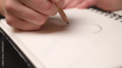 Woman hand drawing apple with pencil in sketchbook. Close up. Slider movement