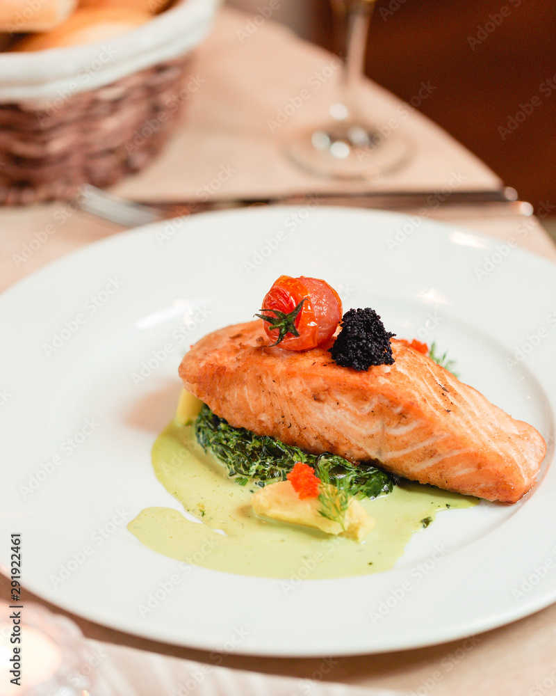 Baked salmon in a sauce with vegetables Baked salmon in a sauce with vegetables