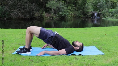 Man training back bridge exercise in park